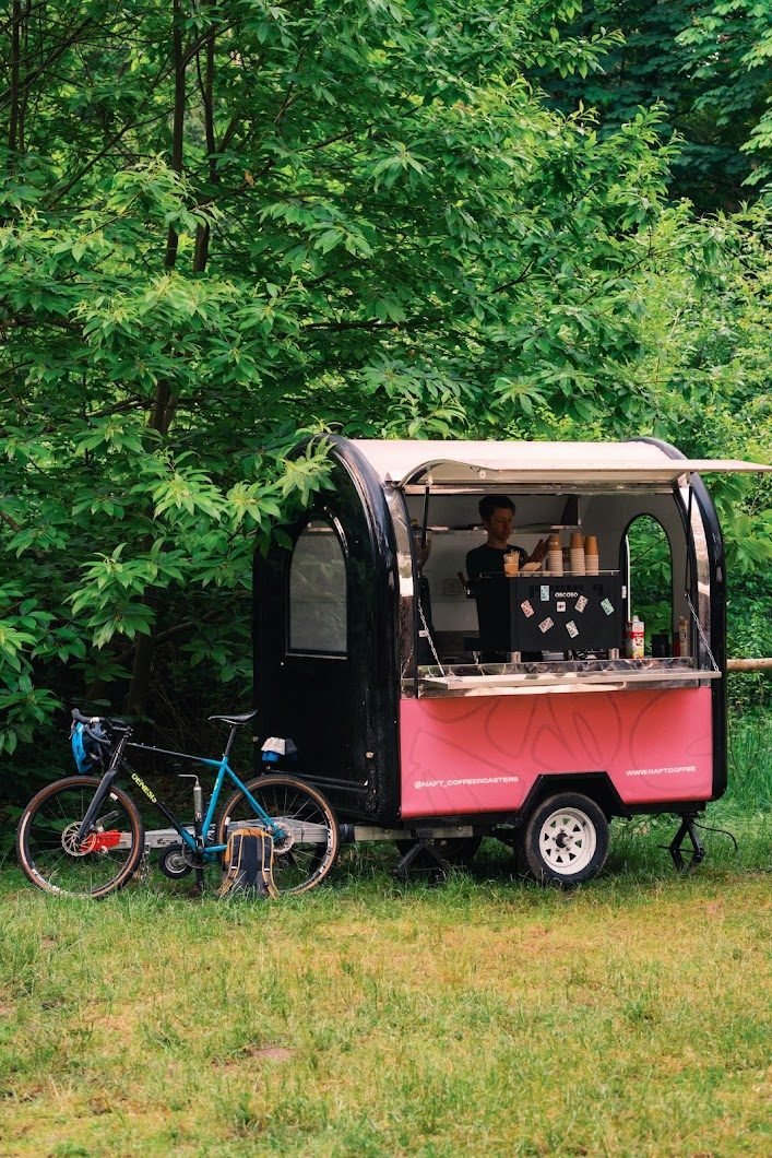 The NAFT coffee truck parked at the edge of the woods